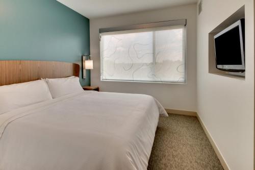 a bedroom with a white bed and a window at Element Ewing Princeton in Ewing