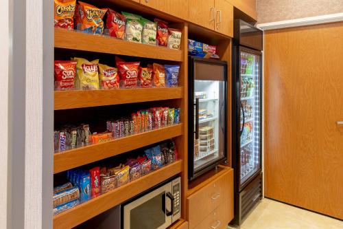 a room with a refrigerator and shelves filled with chips at Fairfield Inn & Suites Minneapolis Eden Prairie in Eden Prairie
