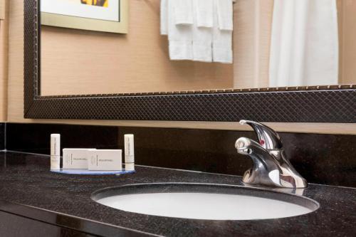 a bathroom sink with a faucet and a mirror at Fairfield Inn & Suites Minneapolis-St. Paul Airport in Mendota Heights