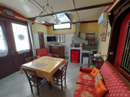 a living room with a table and a couch at Relax Rurale in Fienile Nuovo Malea