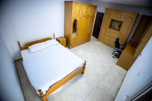 a bedroom with a bed and a desk and a chair at Andalusia Blue Beach Hurghada in Hurghada