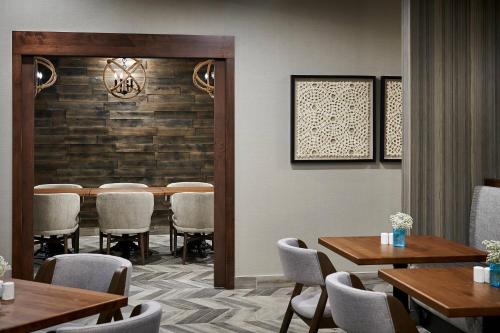 a dining room with a table and chairs in a room at Delta Hotels by Marriott Toronto Mississauga in Mississauga