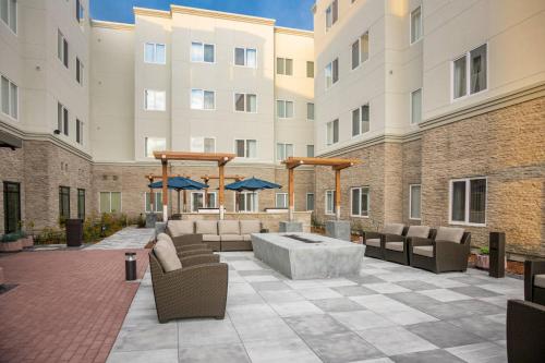 a patio with chairs and a table in front of a building at Fairfield Inn & Suites by Marriott San Jose North/Silicon Valley in San Jose