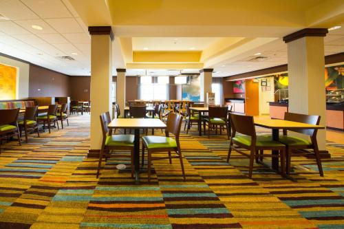 a dining area with tables and chairs in a cafeteria at Fairfield Inn & Suites by Marriott Cordele in Cordele