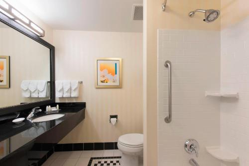 a bathroom with a toilet and a sink and a shower at Fairfield Inn & Suites by Marriott Omaha Downtown in Omaha