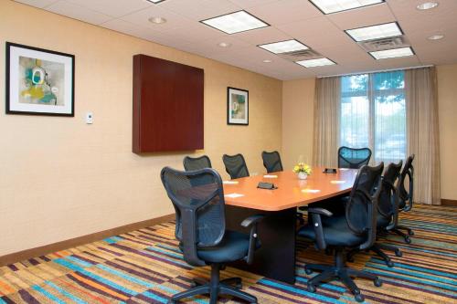 a conference room with a wooden table and chairs at Fairfield Inn & Suites by Marriott Omaha Downtown in Omaha
