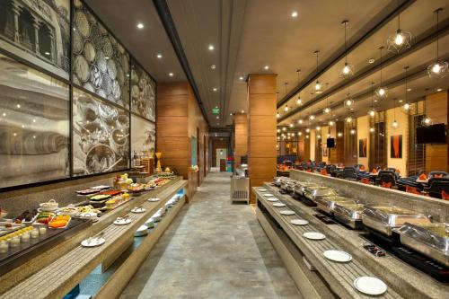 a buffet line in a restaurant with dishes on display at Four Points by Sheraton Chennai OMR in Chennai
