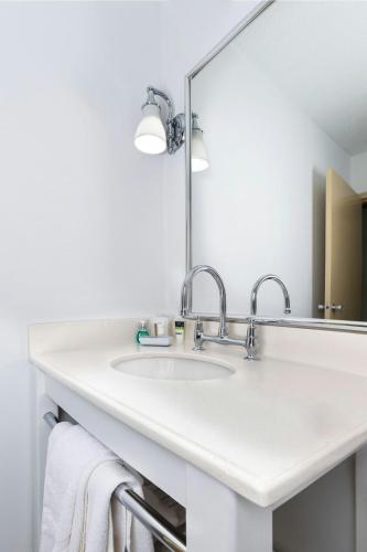 a bathroom with two sinks and a mirror at Four Points by Sheraton Asheville Downtown in Asheville