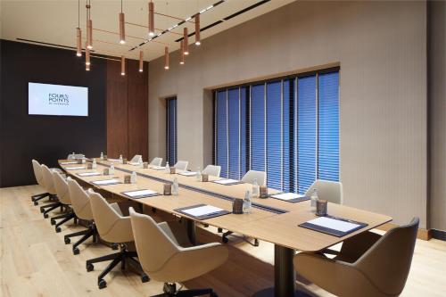 a large conference room with a long table and chairs at Four Points by Sheraton Prishtina City in Pristina