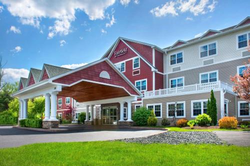 a hotel with a red and white building at Fairfield Inn & Suites by Marriott Great Barrington Lenox/Berkshires in Great Barrington