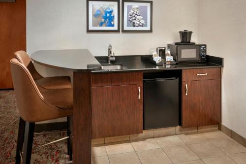 a kitchen with a sink and a table with a microwave at Fairfield Inn & Suites by Marriott Great Barrington Lenox/Berkshires in Great Barrington
