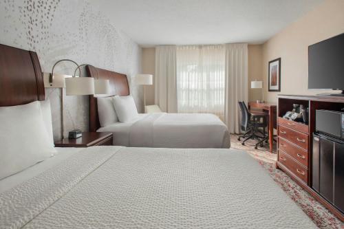 a hotel room with two beds and a desk at Fairfield Inn & Suites by Marriott Great Barrington Lenox/Berkshires in Great Barrington
