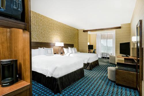 a hotel room with two beds and a flat screen tv at Fairfield Inn & Suites by Marriott Van in Van