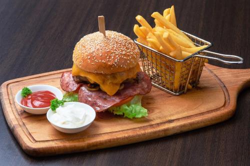 a hamburger and french fries and a basket of fries at Four Points by Sheraton Doha in Doha