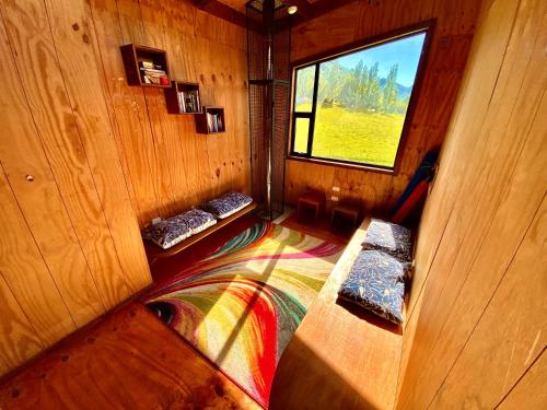 an inside view of a room with a window at Hostal Las Natalias in Futaleufú
