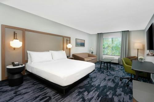a hotel room with a large bed and a desk at Fairfield by Marriott Luquillo Beach in Luquillo