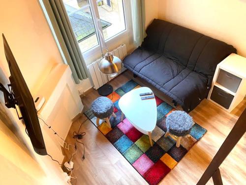 an overhead view of a living room with a couch at Magnolia Home in Caen