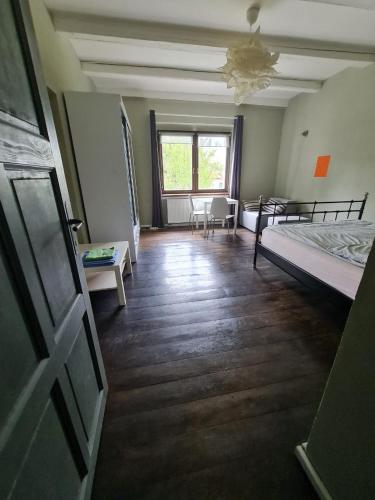 a room with a bed and a table and chairs at Airport Private Apartment, Advance Registration, No Reception, Self Check-in, Calm Environment, Non-Smoking Guests in Kněžívka