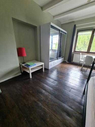 an empty living room with a table and a window at Airport Private Apartment, Advance Registration, No Reception, Self Check-in, Calm Environment, Non-Smoking Guests in Kněžívka
