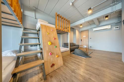 a room with a bunk bed and a ladder at SHIN Arch39 Phuket Beach Front - SHA Plus in Chalong 
