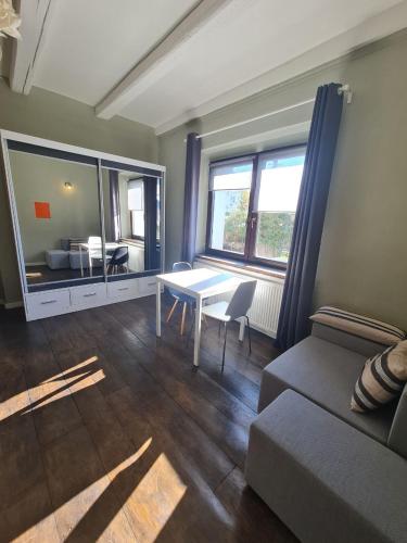 a living room with a table and a couch at Airport Private Apartment, Advance Registration, No Reception, Self Check-in, Calm Environment, Non-Smoking Guests in Kněžívka