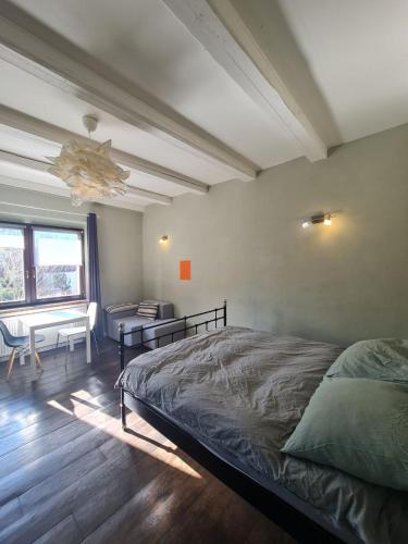 a bedroom with a bed and a desk and a window at Airport Private Apartment, Advance Registration, No Reception, Self Check-in, Calm Environment, Non-Smoking Guests in Kněžívka