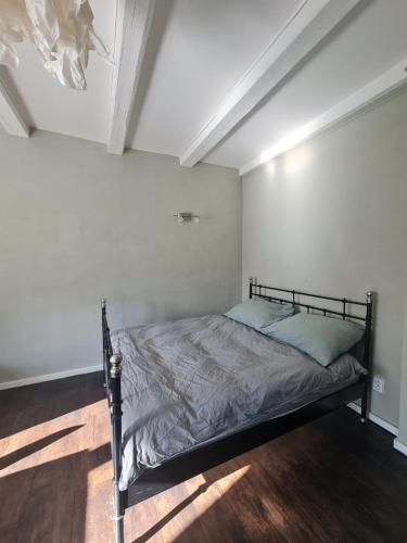 a bedroom with a bed in a white room at Airport Private Apartment, Advance Registration, No Reception, Self Check-in, Calm Environment, Non-Smoking Guests in Kněžívka