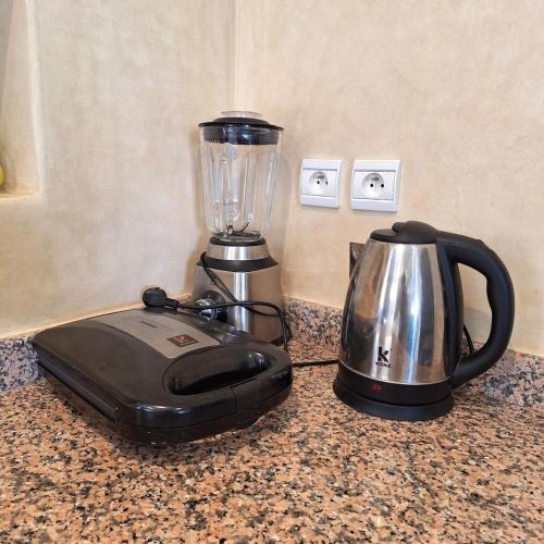 a blender sitting on a counter next to a coffee pot at Azure Horizon Villa Club evasion in Sidi Boulfdail