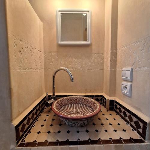 a bathroom with a sink in a bathroom with a mirror at Azure Horizon Villa Club evasion in Sidi Boulfdail