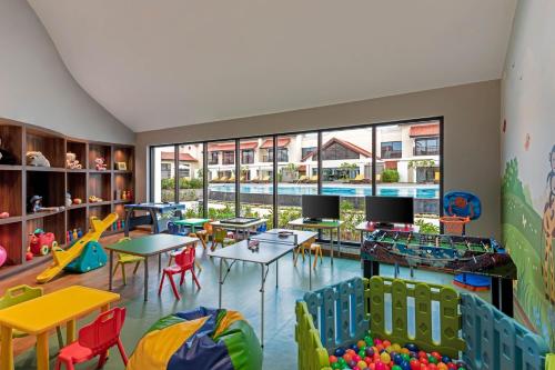 a classroom with tables and chairs and a large window at Fairfield by Marriott Goa Benaulim in Benaulim
