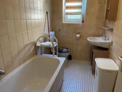 a bathroom with a tub and a sink at POLAT Apartments 7 in Essen