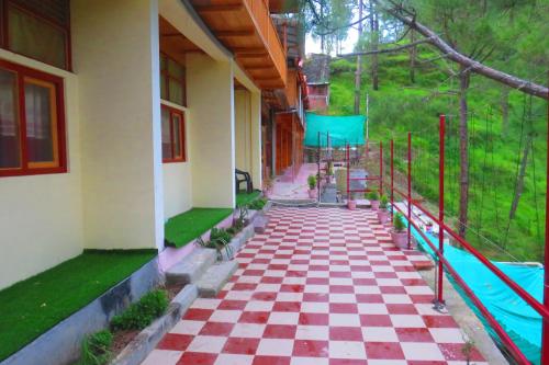 a house with a checkered floor and a playground at Durgesh Hillock in Rānīkhet