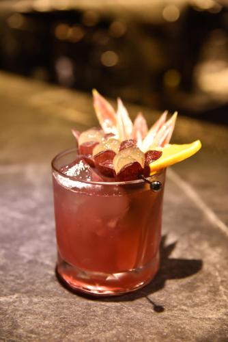 a drink sitting on a table with a flower in it at Two Couples Leisure Art Motel in Tainan