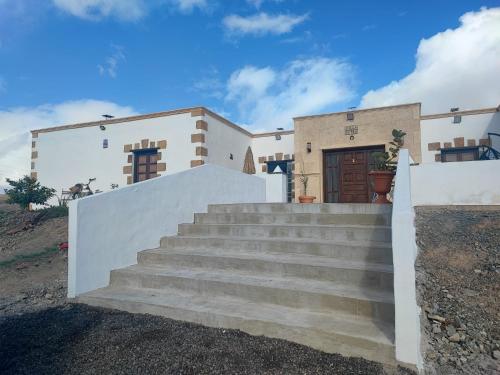a house with stairs in front of it at Villa Petra in Tuineje