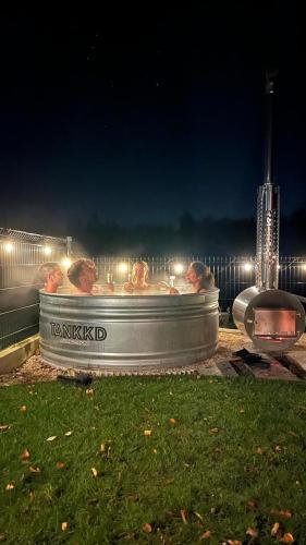 a group of people in a bath tub at night at Het Preshoekhuis in Lauwe