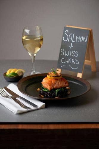 a plate of food and a glass of wine on a table at Delta Hotels by Marriott Toronto Airport & Conference Centre in Toronto