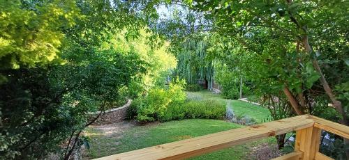 a view of a garden from a wooden deck at Willow's Rest in Barrydale