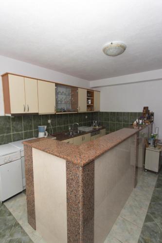 a large kitchen with a large counter top at Casa Del Pellegrino M&A - Ostojići in Međugorje
