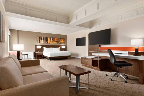 a large hotel room with a bed and a desk at Delta Hotels by Marriott Saint John in Saint John