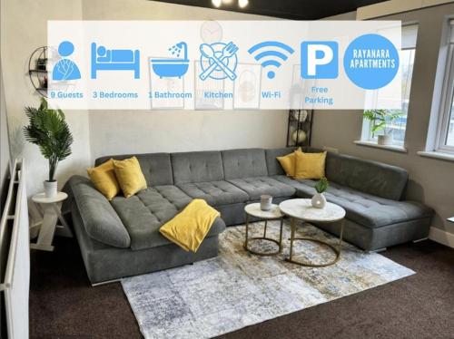 a living room with a gray couch and yellow pillows at Sleeps 8 3 BED Parking NEC JLR NIA Airport in Birmingham