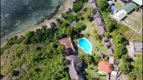 an aerial view of a beach with a swimming pool at Cuestas Beach Resort and Restaurant in Badian