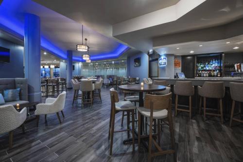 a restaurant with tables and chairs and a bar at Delta Hotels by Marriott Regina in Regina
