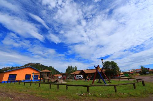 a park with a playground with a blue sky at Villa Mexicana Creel Mountain Lodge in Creel
