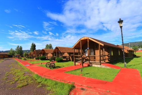 a building with a red path in front of it at Villa Mexicana Creel Mountain Lodge in Creel