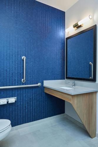 a bathroom with a sink and a blue wall at Fairfield Inn & Suites Burlington in Burlington