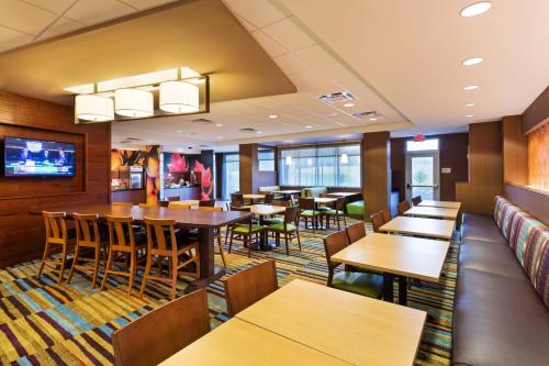 a restaurant with tables and chairs and a couch at Fairfield Inn & Suites by Marriott Johnson City in Johnson City