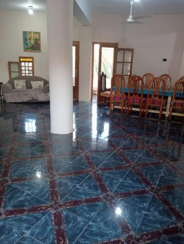 a living room with a blue tiled floor at New Oasis 2 in Bawiti