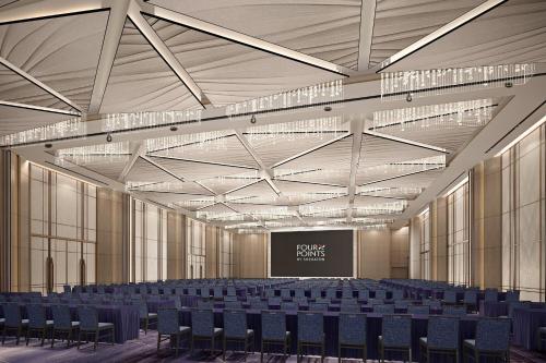 a large room with chairs and a projection screen at Four Points by Sheraton Changzhou Economic Development Zone in Changzhou