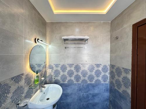 a bathroom with a sink and a mirror at Mukhtar Homes Bahria Town Lahore in Lahore