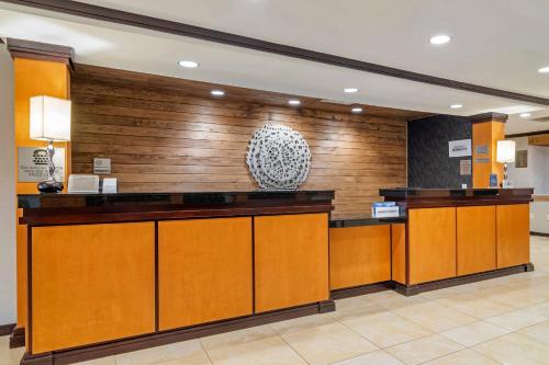 a lobby with wooden walls and a reception desk at Fairfield Inn & Suites by Marriott Commerce in Commerce